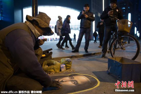 2016年1月14日，江苏省南京市，“粉笔画大叔”在南京街头作画，吸引众多市民驻足观看。据作画者本人介绍，他靠悟性自学作画，以乞讨为生，画完一幅约9至10个小时。